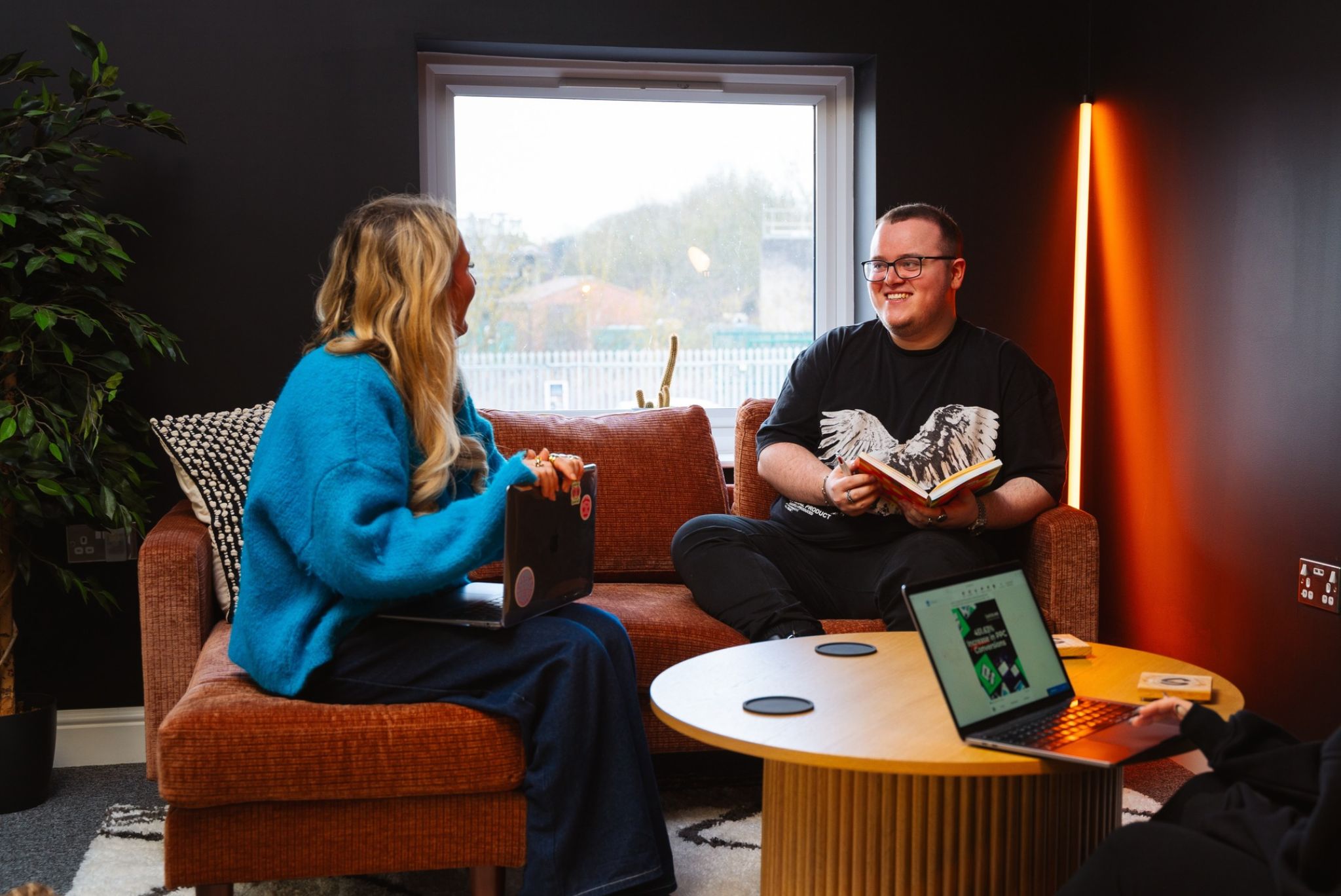Our Design and Animation Specialist Elliot chats on the sofa of our music room to Lily, Social Media Lead about the Power of Motion in Social Advertising
